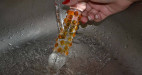 Sklenené Dildo Orange, pod tečúcou vodou